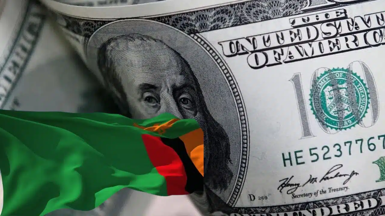 two United States dollar notes in background and the Zambian flag in the foreground
