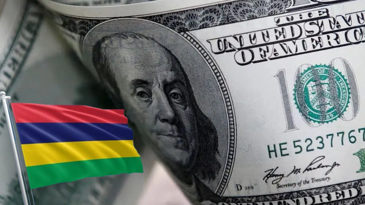 The Mauritius flag positioned in front of a close-up shot of a fanned-out US dollar note bundle, symbolising investment and financial growth in Mauritius.