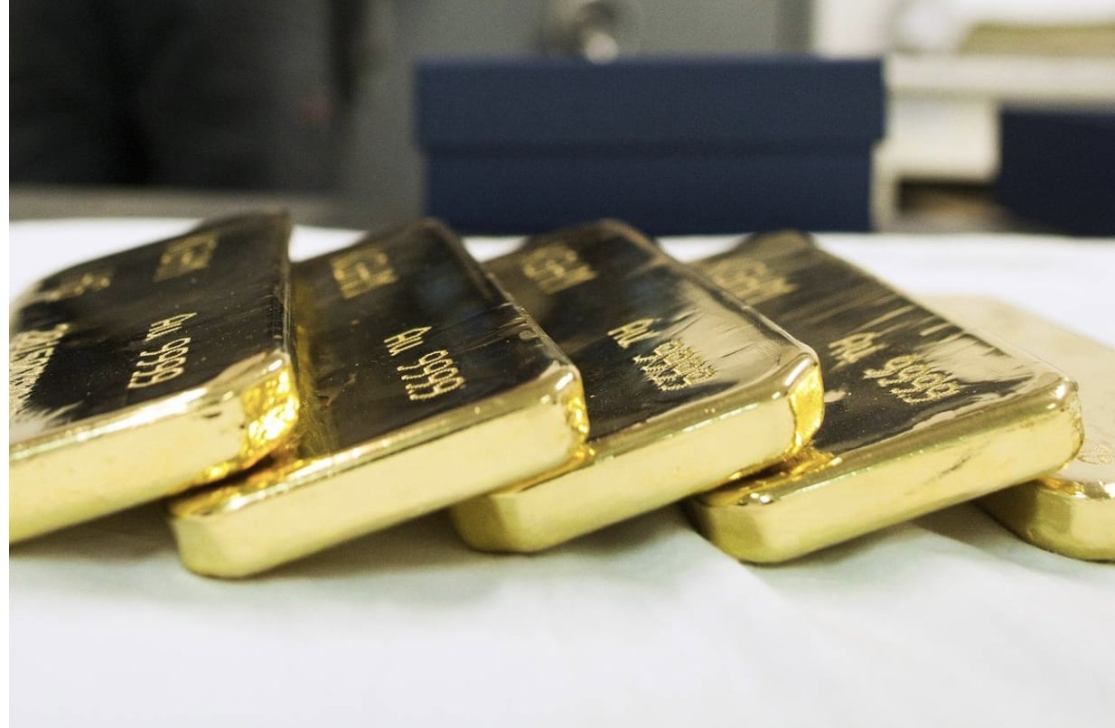Newly-cast bullion gold bars sit in safe room
