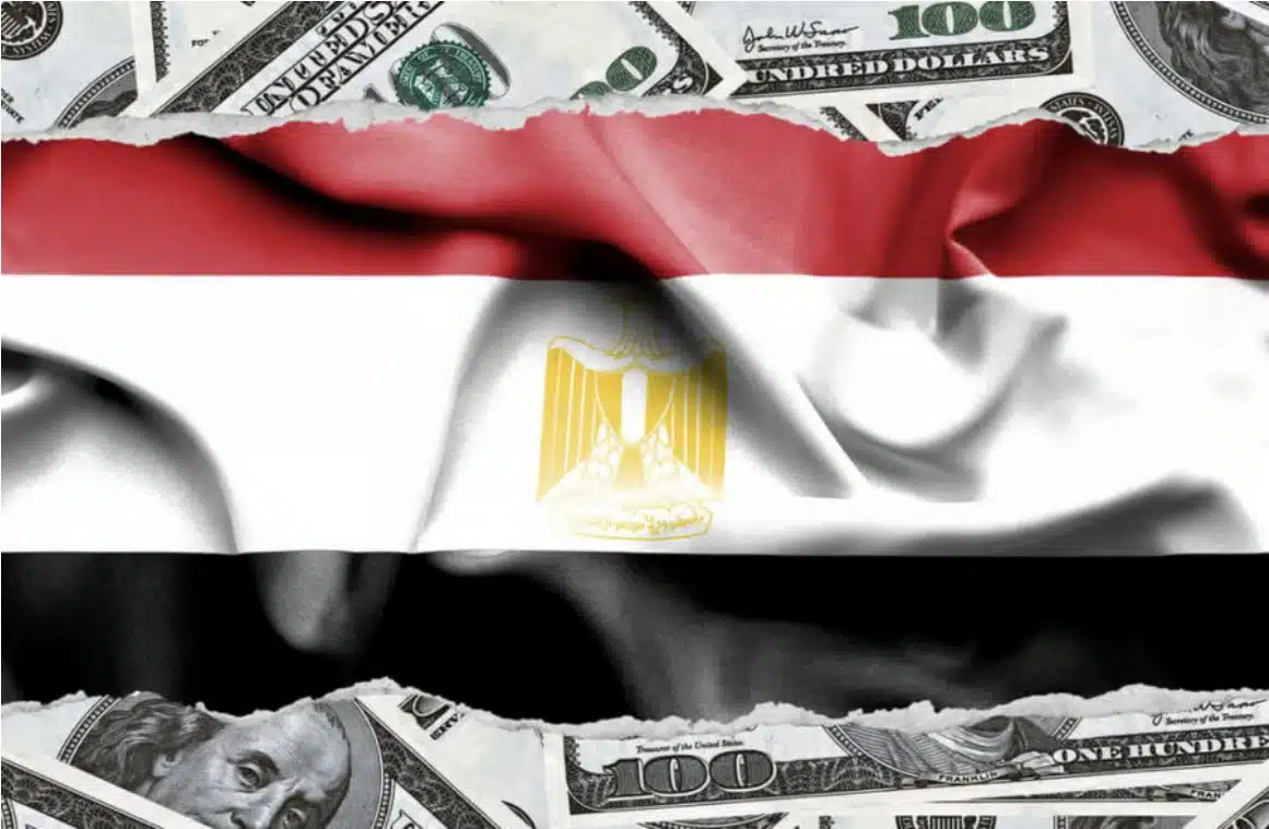 An Egyptian flag stretched across the image, against a background of scattered dollar bills, symbolising Egypt' s surge in foreign direct investments