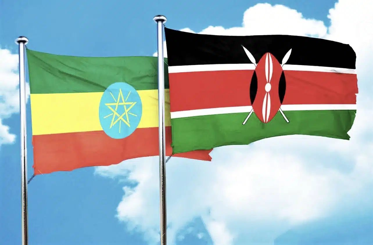 An Ethiopian flag and a Kenyan flag on separate poles.