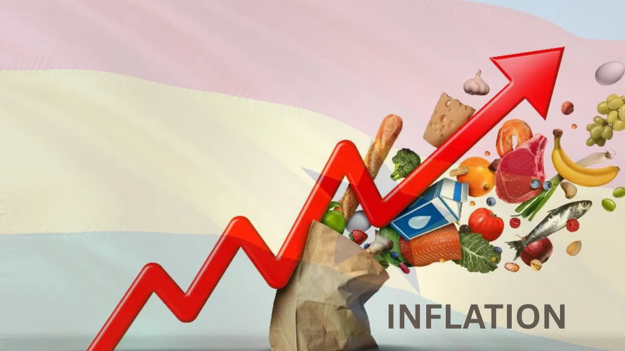 Various food items and fruits emerging from a brown paper bag, with a crooked arrow cutting across and Ghana's flag in the background, symbolising inflation in Ghana.