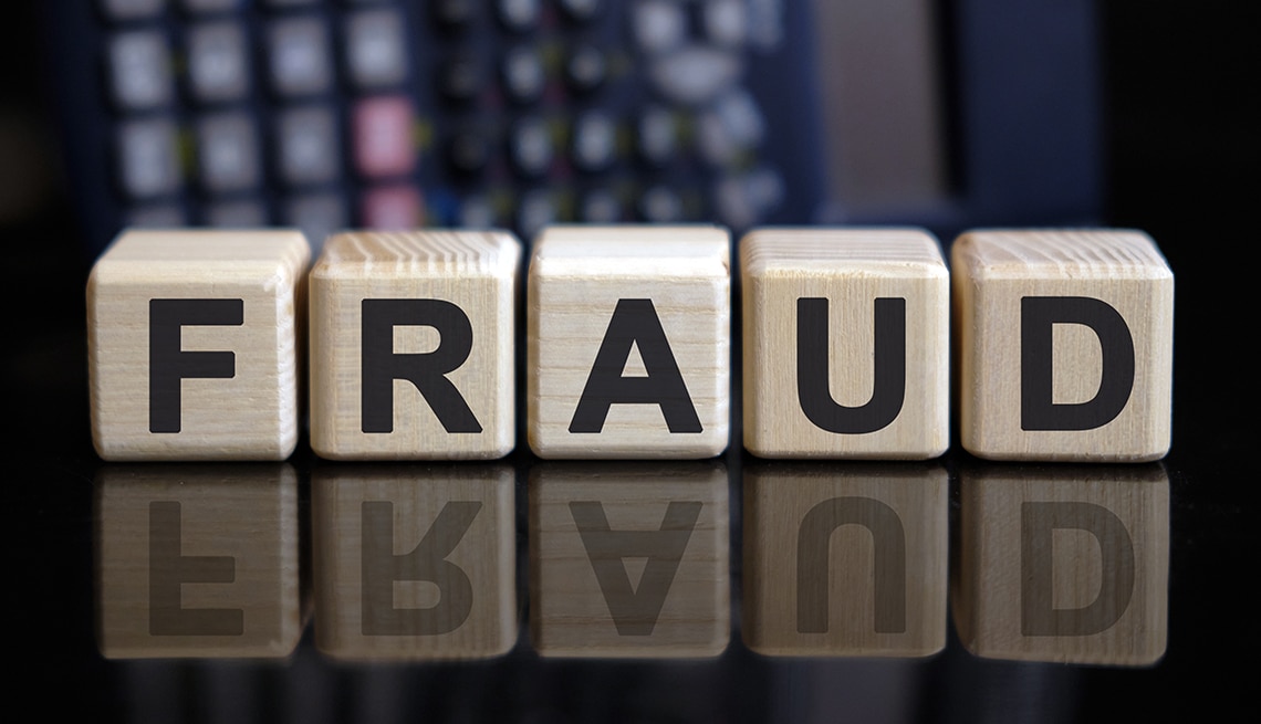 Wooden cubes with the word "Fraud" in bold letters, against a blurry background, synmbolising bank fraud cases