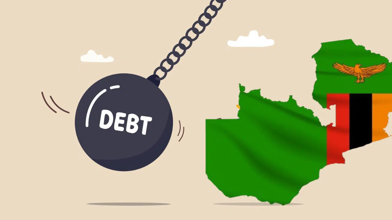 A “debt” wrecking ball swinging towards the Zambia flagged framed in the country’s shape