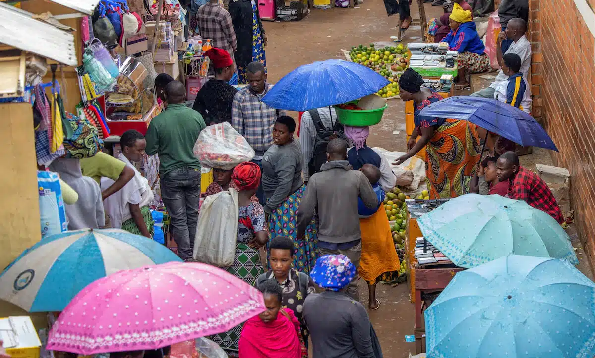 Residents walk at an open air grocery market in the outskirts Kigali, Rwanda,