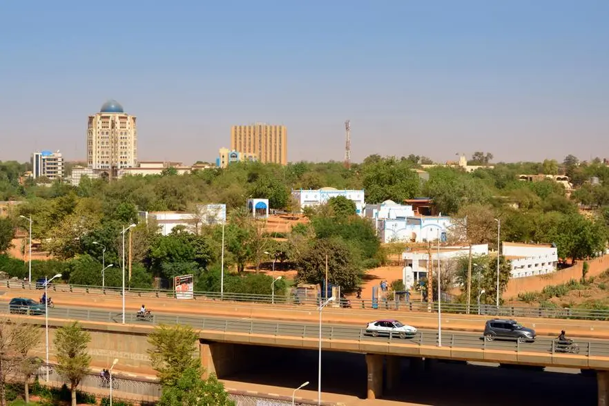 A cityscape featuring a modern urban area in Africa with a mix of tall and low-rise buildings surrounded by abundant greenery.