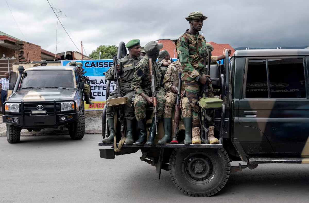 Members of the M23 rebel group ride on their vehicles after the opening ceremony of Caisse Generale d'epargne du Congo in Goma, North Kivu province in the East of the DRC