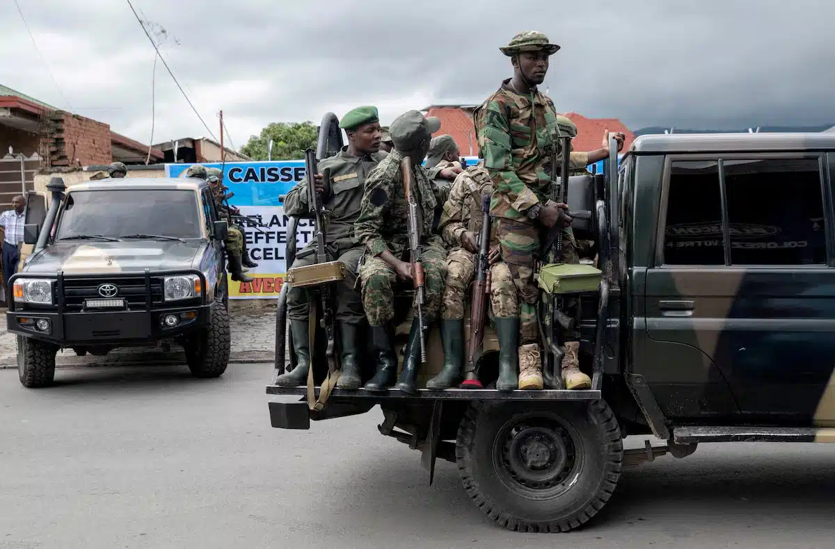 Members of the M23 rebel group ride on their vehicles after the opening ceremony of Caisse Generale d'epargne du Congo in Goma, North Kivu province in the East of the DRC