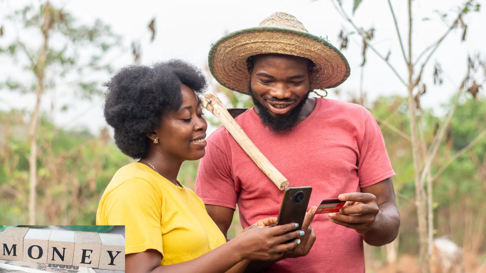 Two people trying to use mobile money